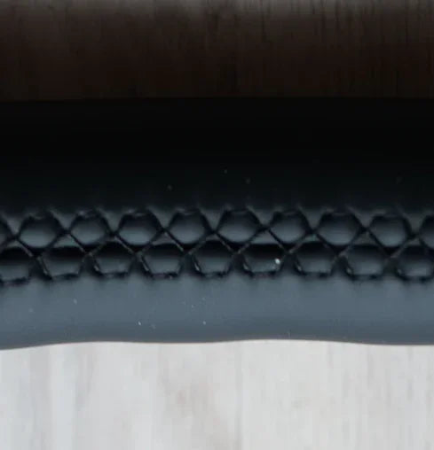Close-up of BMW F Series steering wheel with black honeycomb textured grip