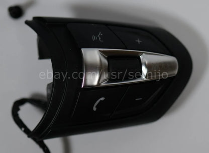 BMW F Series M Sport steering wheel button controls with phone, mode, and voice icons