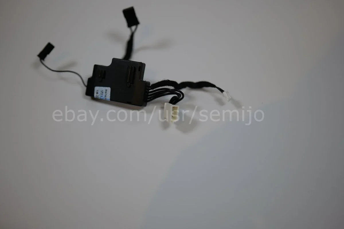 Steering wheel control module with wiring harness for BMW F Series on plain background.
