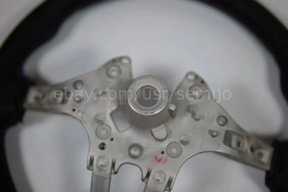 Close-up of BMW F Series M Sport steering wheel metal frame, circular mount center