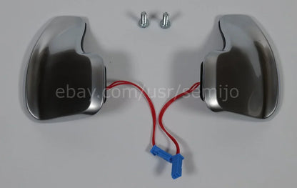 Silver BMW F Series M Sport steering wheel paddle shifters with red wires and screws