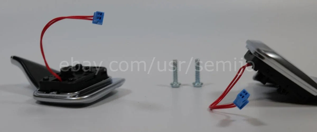 BMW F Series steering wheel paddle shifters with wiring and mounting screws on white background