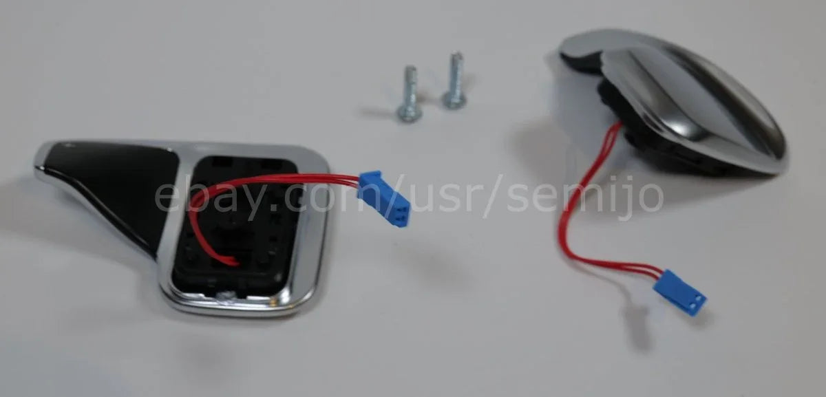 BMW F Series steering wheel paddle shifters with wiring and screws on white background