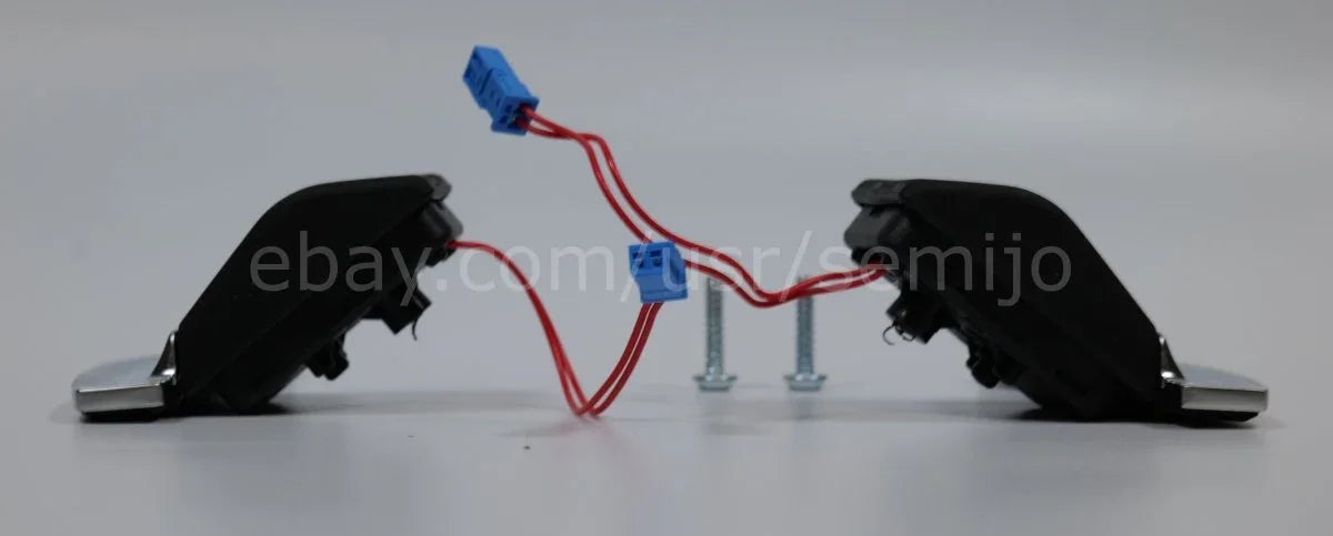 BMW F Series M Sport steering wheel paddle shifters with wiring and screws on white background