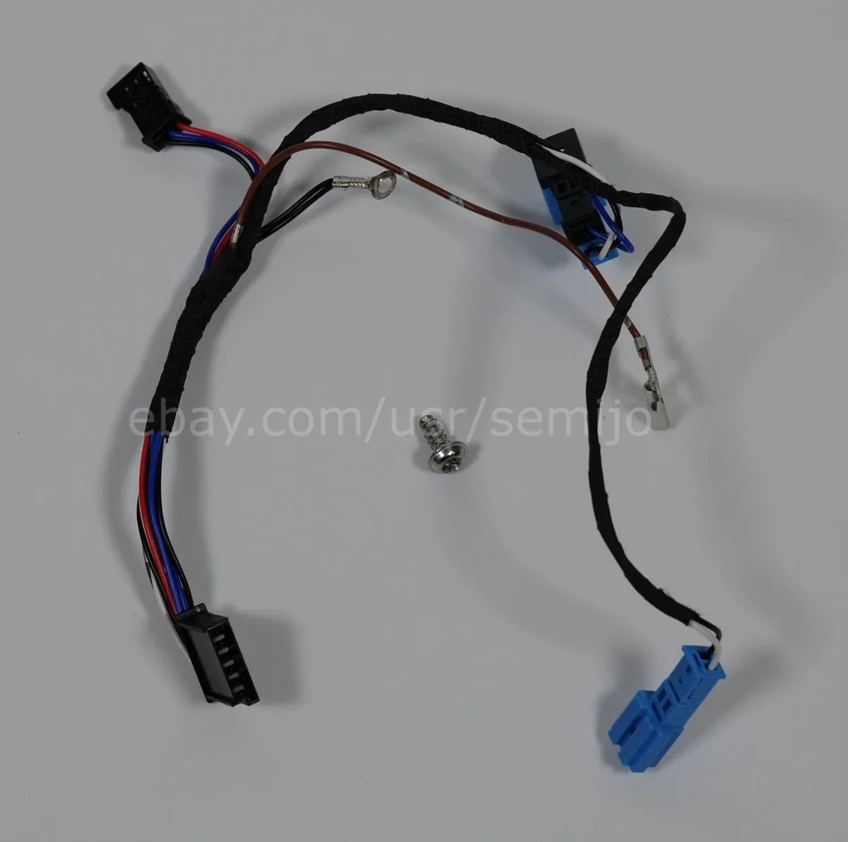 BMW F Series steering wheel wiring cable with connectors and a screw on white background