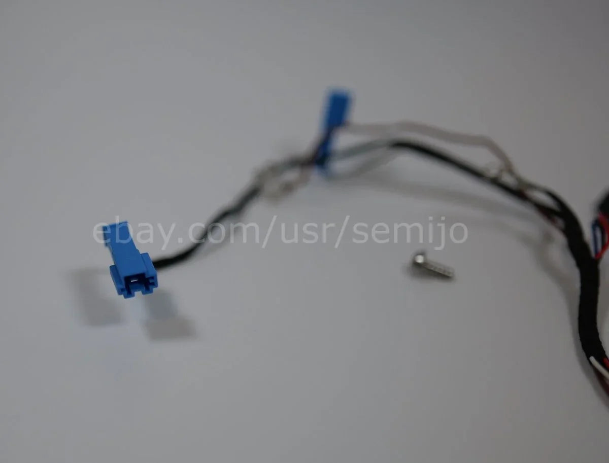 BMW F Series steering wheel wiring cable connectors with blue plugs and screw on white background